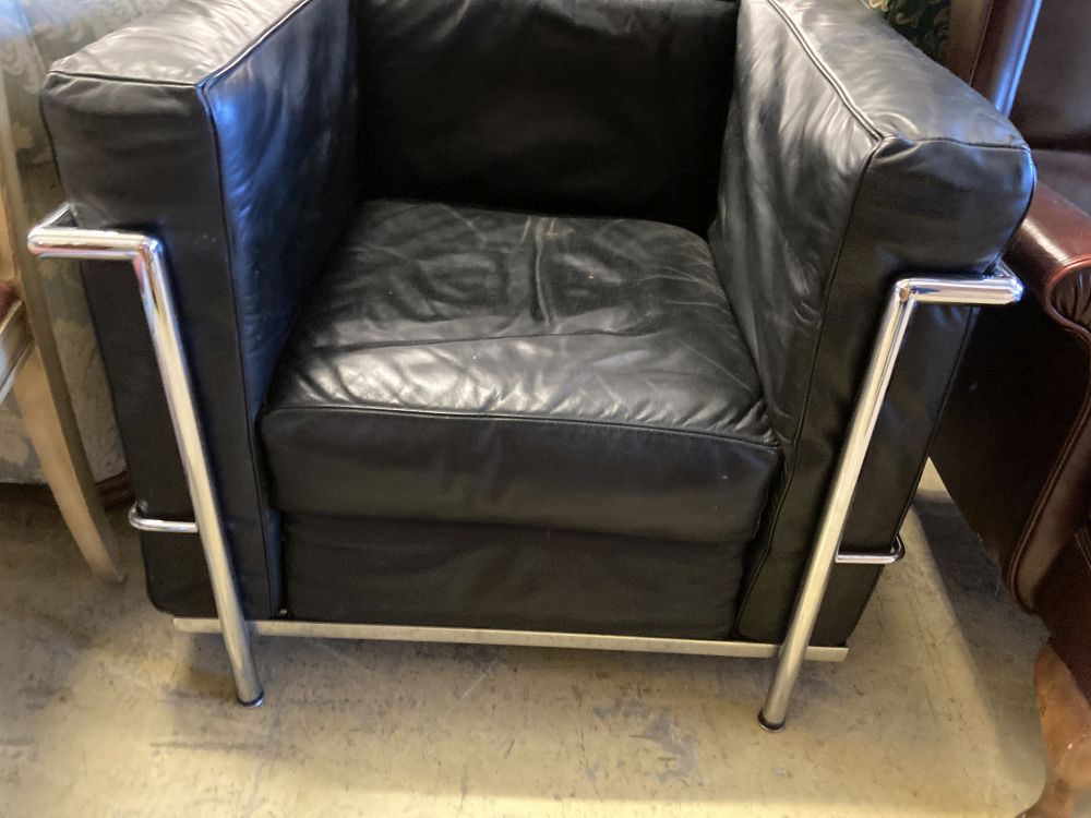 A pair of Le Corbusier style leather and chrome chairs, width 76cm, depth 70cm, height 65cm